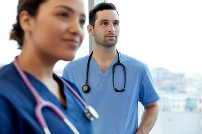  Medical students with 3M™ Littmann® Stethoscopes talking with each other.